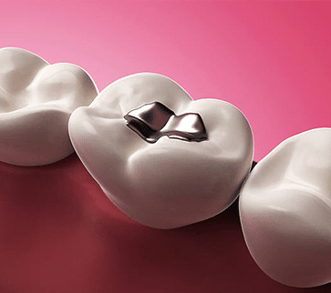 Silver wedding rings nestled in white heart-shaped cushions against pink background.