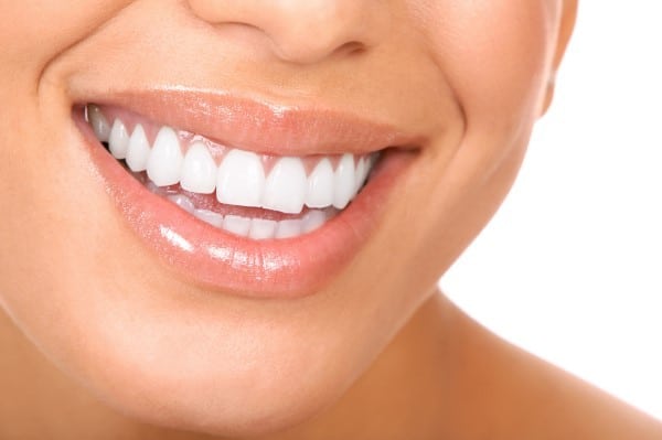 Close-up of a person's bright, white smile showcasing healthy teeth and gums.