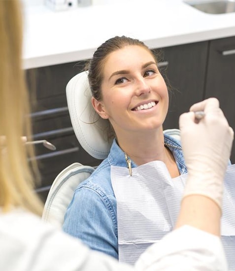 Woman receiving dental examination from dentist in clinical setting at Danville Family Dental
