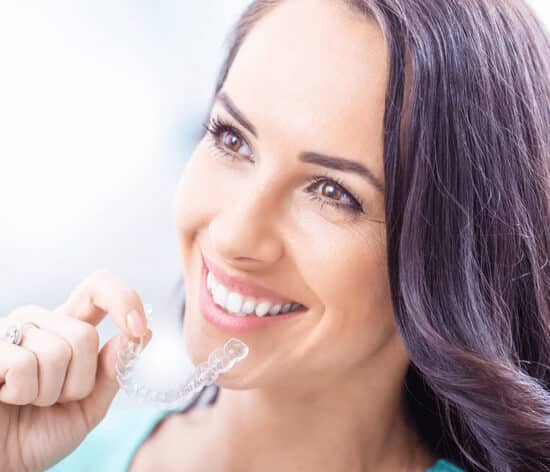 A girl showing Invisalign